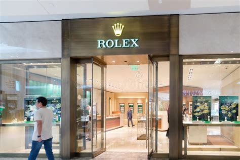 Brand Rolex store in shopping mall. Entrance view, bright sign .